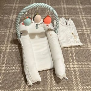 DockATot Deluxe+ lounger, spare cover, and toy arch